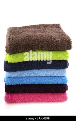 Multicolored towels on a pink background. Pink, beige, yellow, orange