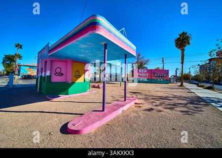 Colorful Graffiti Gas Station with Butterfly Mural in Desert Urban Scene Stock Photo