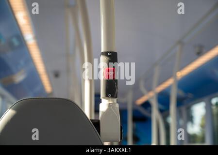 Red stop button on a public bus, press to tell the driver you want the next available stop.  UK April 2025. Stock Photo