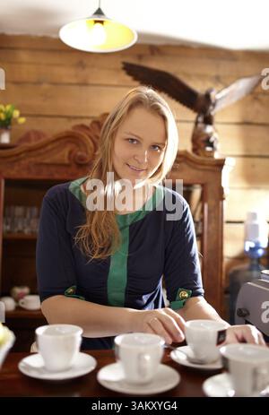 Young beautiful woman is making coffee in country house Stock Photo
