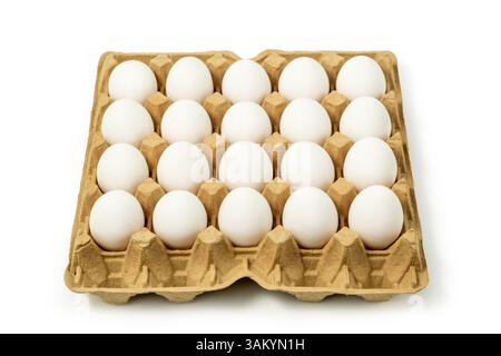 Top view of white chicken eggs in the cardboard egg tray with rooms for twenty eggs isolated on white background, with clipping path included Stock Photo