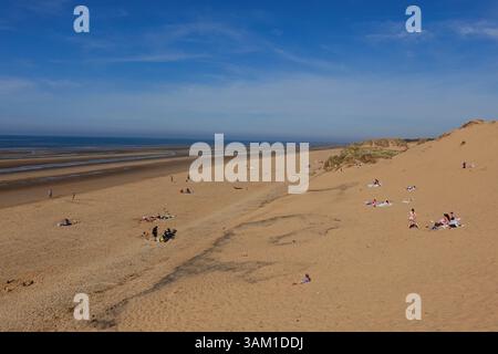 People are enjoying a sunny day at the seaside on a Formby beach in the UK Stock Photo