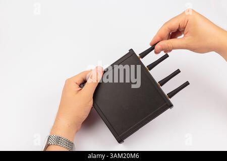 Hands of a master holding an electronic board on a white background Stock Photo