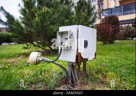 old rusty electrical box with improvised modifications suggests danger carelessness abandonment Stock Photo