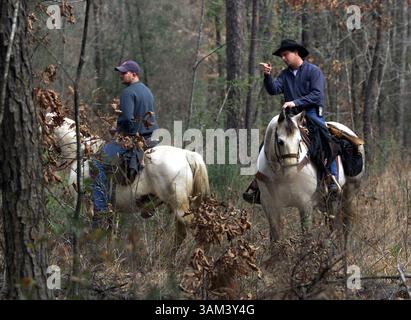 Feb. 2, 2003 - U.S. - NO MAGS, NO SALES UNTIL 2/16/2003 --KRT US NEWS STORY SLUGGED: SHUTTLE KRT PHOTO BY RICK MOON/FORT WORTH STAR-TELEGRAM (DALLAS OUT) (February 2) HEMPHILL, TX -- Bradley Byley, right, and Dale wilkerson head into woods near Hemphill, Texas, on Sunday, February 2, 2003, searching for debris from the space shuttle Columbia which broke up as it returned to Earth on Saturday. (gsb) 2003 (Credit Image: © Rick Moon/mct/ZUMAPRESS.com) Stock Photo