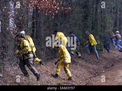 Feb. 2, 2003 - U.S. - NO MAGS, NO SALES UNTIL 2/16/2003 --KRT US NEWS STORY SLUGGED: SHUTTLE KRT PHOTO BY RICK MOON/FORT WORTH STAR-TELEGRAM (DALLAS OUT) (February 2) HEMPHILL, TX -- Members of the National Forest Service and volunteers head into woods near Hemphill, Texas, on Sunday, February 2, 2003, searching for debris from the space shuttle Columbia which broke up as it returned to Earth on Saturday. (gsb) 2003 (Credit Image: © Rick Moon/mct/ZUMAPRESS.com) Stock Photo