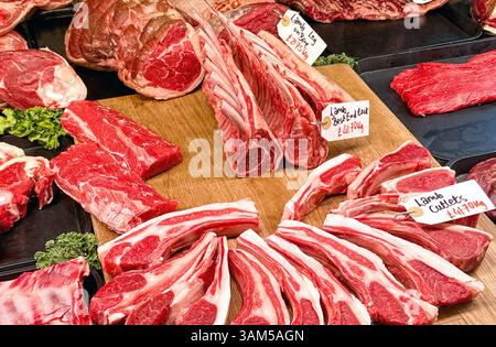 Selection of joints of fresh lamb on a butcher's stall in a market. No people. Stock Photo