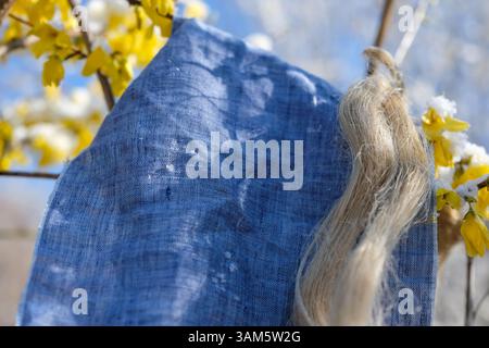 Delicate and Airy Nature of Blue Linen Fabric in a Springtime Setting. Gentle Touch, Sustainability, and Slow Living. Natural Fibers, Fashion. Stock Photo