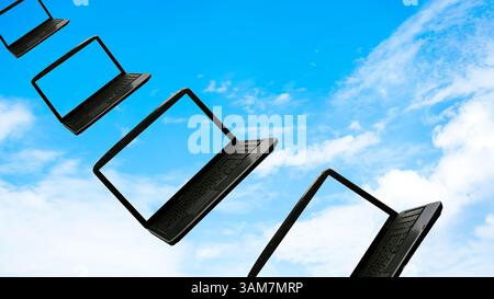 Laptops flying along the blue sky, concept cloudcomputing Stock Photo