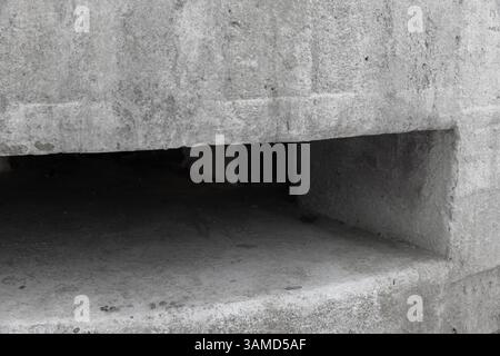 Detailed image showcasing a textured concrete structure featuring an open rectangular cavity Stock Photo