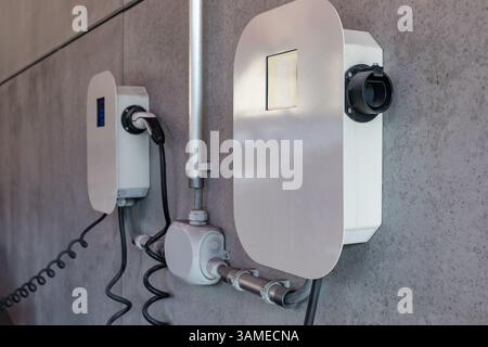 electric charger on a concrete wall Stock Photo