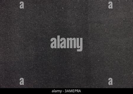 Dark textured black surface background with subtle grain. Stock Photo