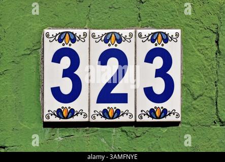 Street sign number 323 on a green wall, Rio de Janeiro, Brazil Stock Photo