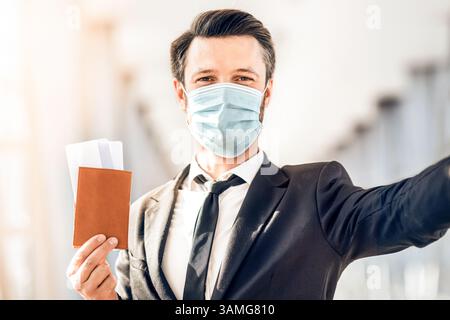 Businessman in face mask taking selfie before departure Stock Photo