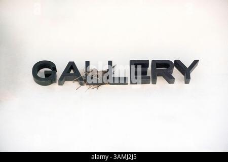 Bird in nest on building sign Stock Photo
