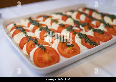 Close-up of tomato and mozzarella slices with herb pesto, Europaeischer Hof, Koenigsbach Stein, Germany, Europe Stock Photo