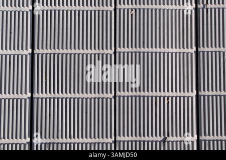 Grey rectangular tiles with vertical ridges close up textured background Stock Photo