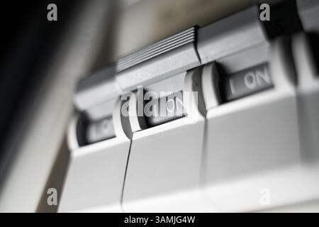 Close-up of a switchboard with a toggle switch turned on. Stock Photo