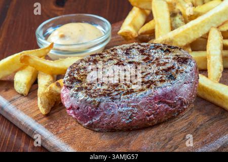 Close-up of a steak with chips and sauce Stock Photo