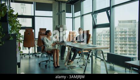 Business colleagues having coffee in modern office Stock Photo