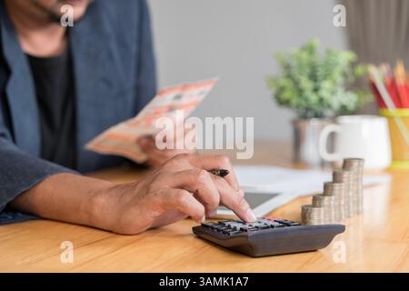 Restaurant owner checking monthly reports on a tablet, bills and expenses of his small business. Start-up entrepreneur concerned about financial repor Stock Photo