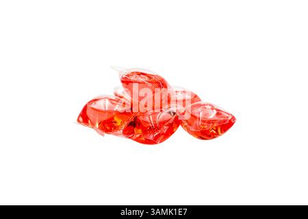 Capsules with detergent for washing machine, isolated on a white background. Red gel Capsules Stock Photo