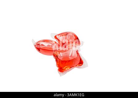 Capsules with detergent for washing machine, isolated on a white background. Red gel Capsules Stock Photo