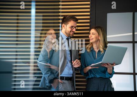 Business professionals collaborating on a project in a modern office. Team of coworkers sharing idea Stock Photo