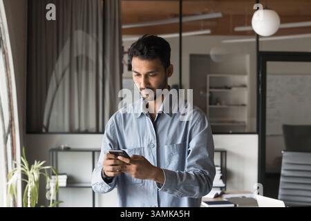 Successful Modern Indian Businessman using smartphone Stock Photo
