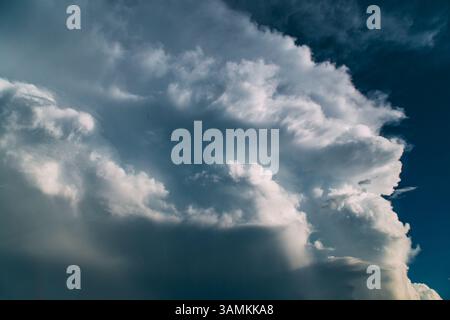 Large white thunderhead cloud in blue sky Stock Photo