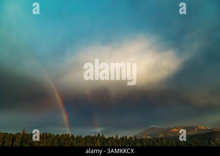Double rainbow over Colorado Rocky Mountains Stock Photo