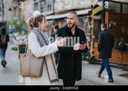Friends engaging in a lively conversation while walking together outdoors Stock Photo