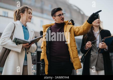 Young business professionals engaging outdoors in a collaborative discussion Stock Photo