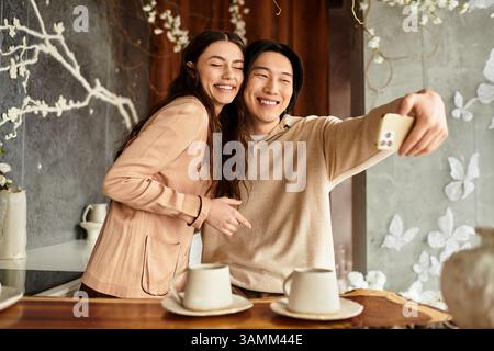 Excited couple sharing smiles as they capture a joyful moment while planning their wedding. Stock Photo