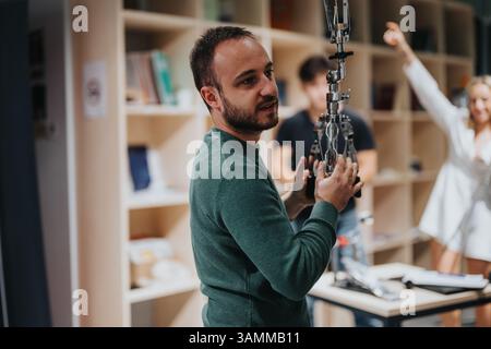 Man engaging with technology in a collaborative and creative workspace environment Stock Photo