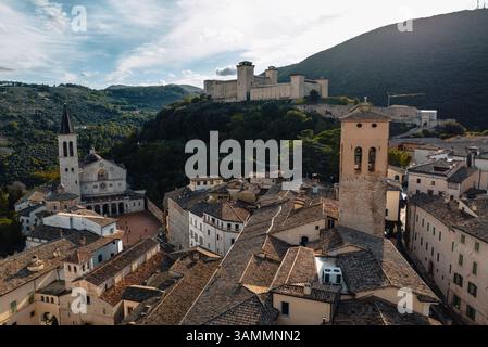 Aerial view of medieval architecture and historic buildings in a picturesque old town with rooftops and a fort, Spoleto, Italy. Stock Photo