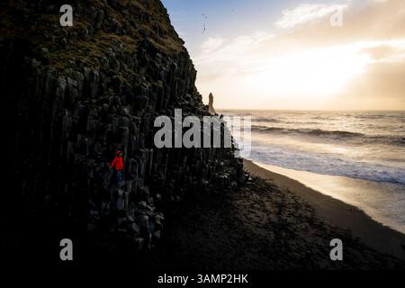 Aerial view of basalt columns and one person at Reynisfjara black beach ...