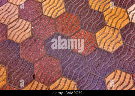 Pedestrian walkway tiles in Valencia, Spain feature a hexagonal pattern with a textured surface Stock Photo