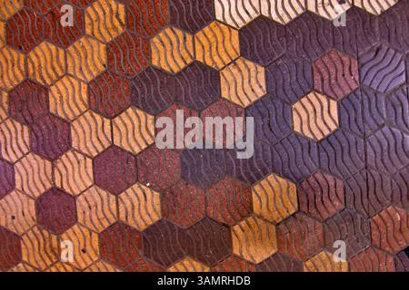 Pedestrian walkway tiles in Valencia, Spain feature a hexagonal pattern with a textured surface Stock Photo