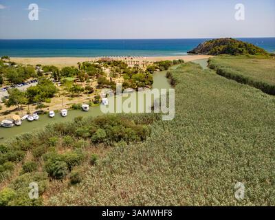 Aerial view of sandy beach, river, and boats, Sarigerme, Turkey. Stock Photo