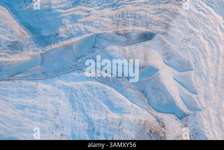 Aerial view of white cotton castle thermal spring with glacial forms and snow, Pamukkale, Turkey. Stock Photo