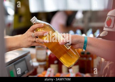Apple juice on sale at the Hauterives market in the Drôme department (south-eastern France) Stock Photo