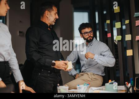 Business professionals engaging in a creative brainstorming session with sticky notes Stock Photo