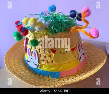 Hat easter bonnet yellow hat colour coloured big brim eggs chicks chicken chickens nice top hat straw design designed green yellow blue red pink Stock Photo