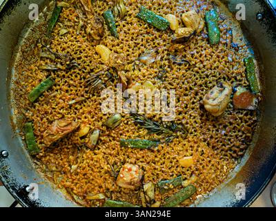Freshly made Valencian paella in its corresponding container. Stock Photo