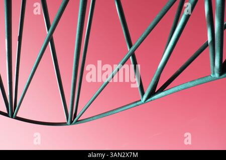 Contemporary pipe figure crafted from silver steel against neon colorful wall Stock Photo