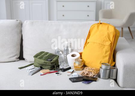 Survival kit. Different emergency supplies on sofa indoors Stock Photo