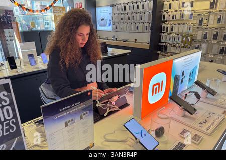 Young woman trying technology in store Stock Photo