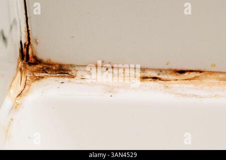 cracked ceramic tile background with dust and aged look close detail of dirty broken floor tile in old building damaged surface texture with cracks Stock Photo