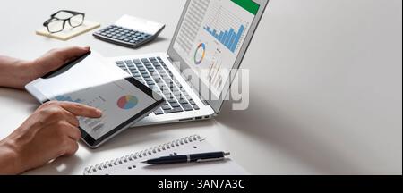 Man using tablet and laptop, financial app. Analyst at work Stock Photo
